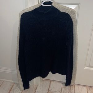 An adorable navy with one white stripe on the sides sweater!!